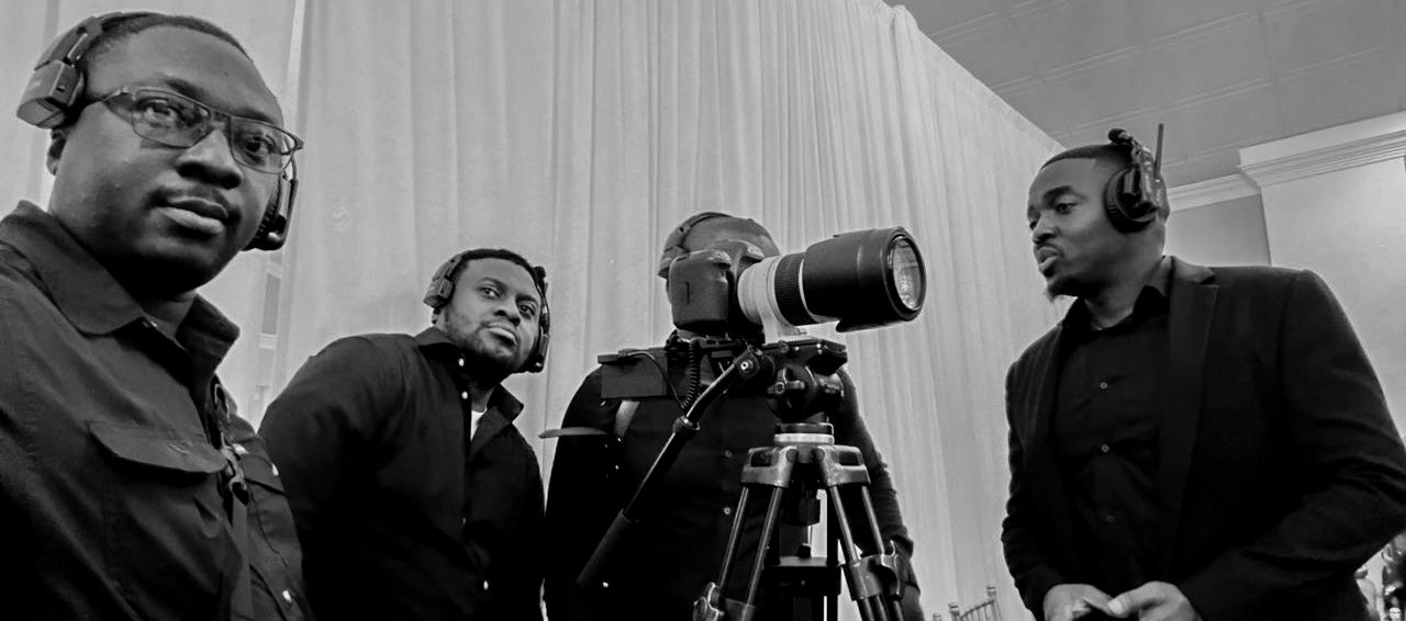 The Judge Media crew reviewing footage on set with a telephoto lens camera