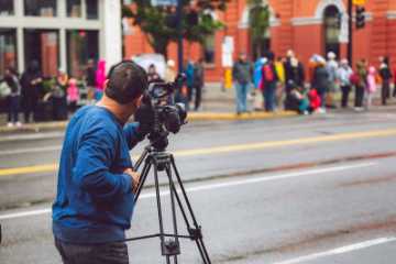Videographer filming on location for a documentary project